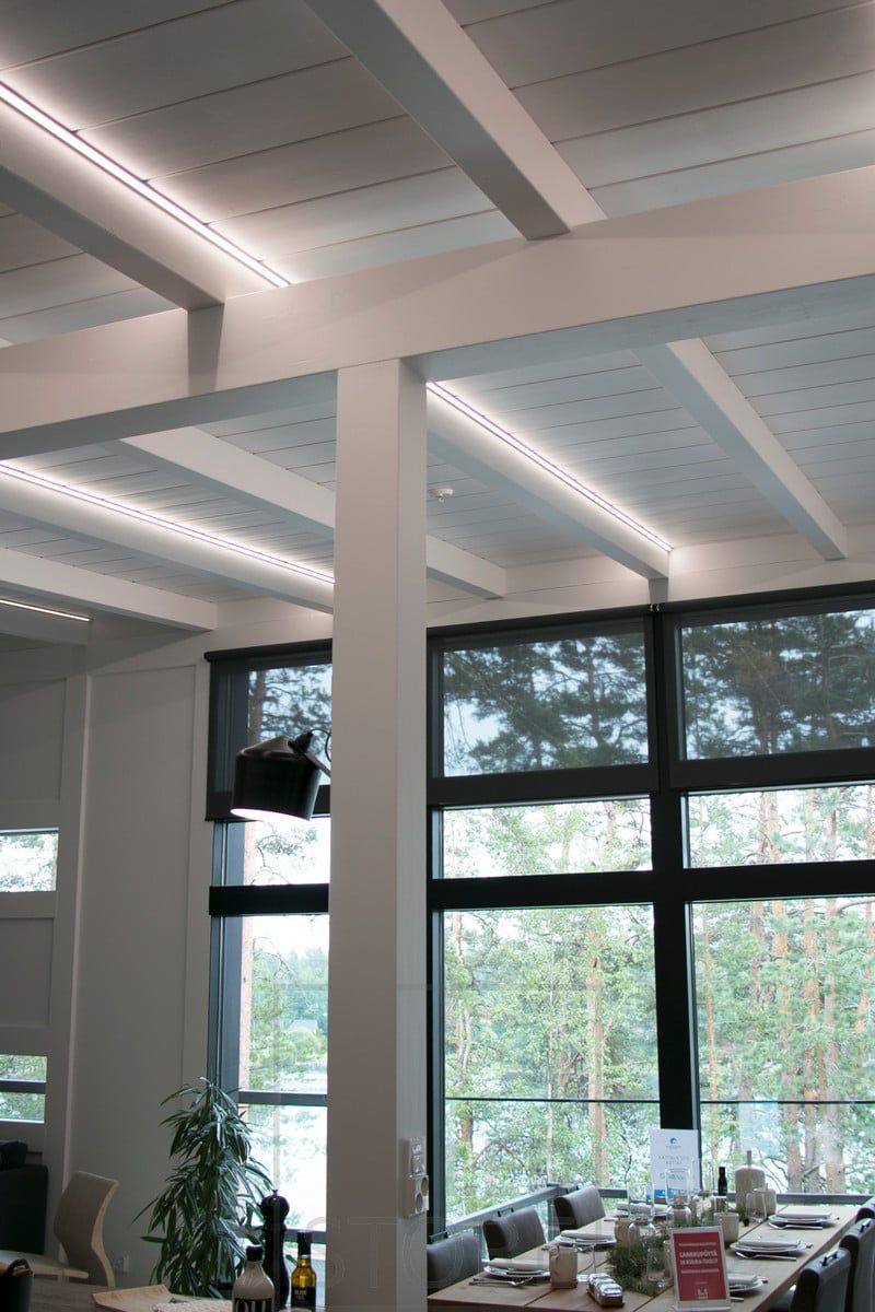 Led strips highlighting the beams, also create a good and high quality general lighting of the space.